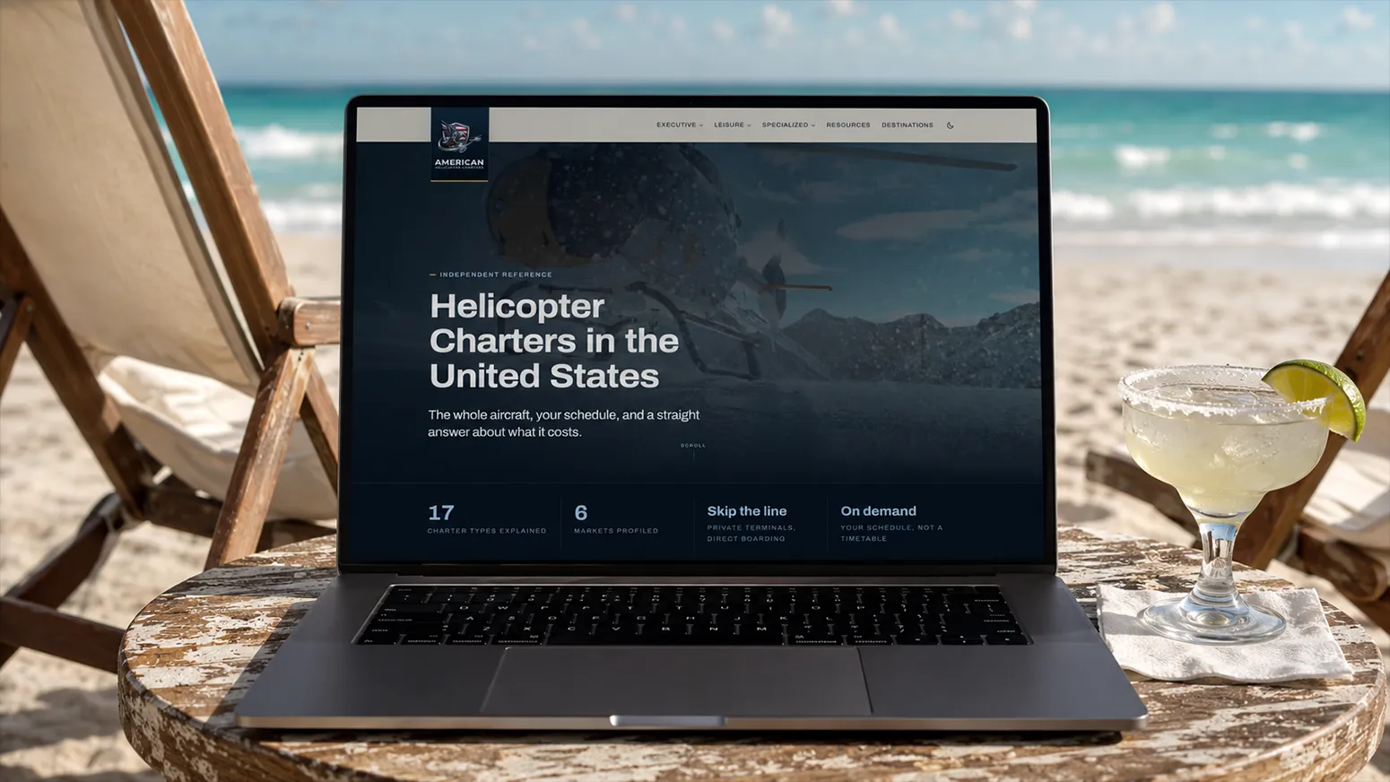 The HelicopterCharters.us website displayed on a laptop at a beachside table